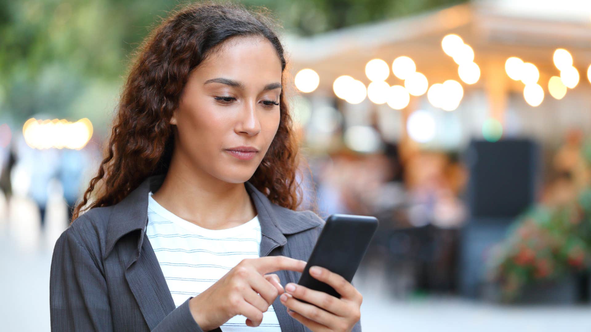 woman looking through her text messages