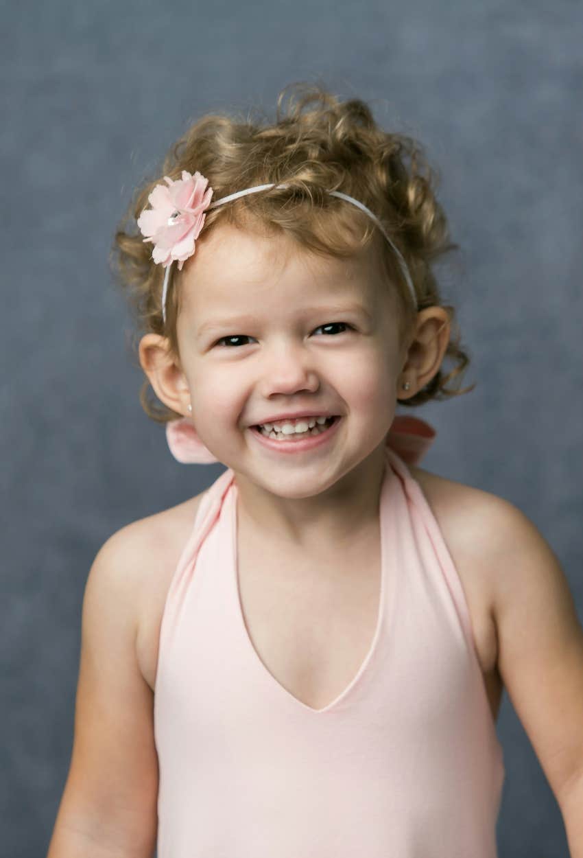 flower girl with curly hair and headband for wedding