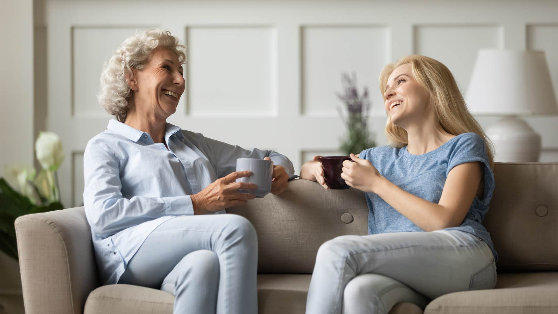 older woman having cup of coffee with adult daughter