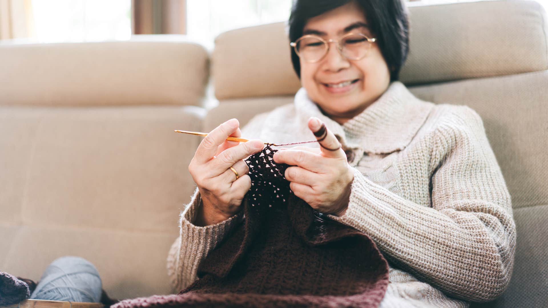 older woman sewing clothes