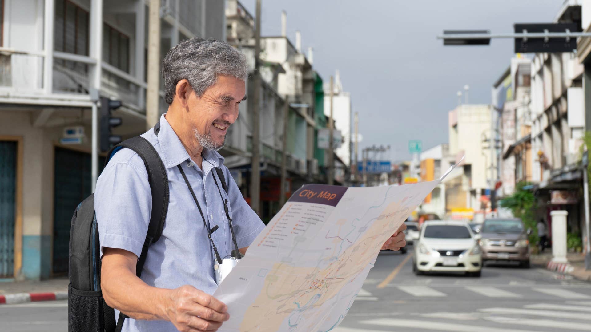 older man using physical map to get around