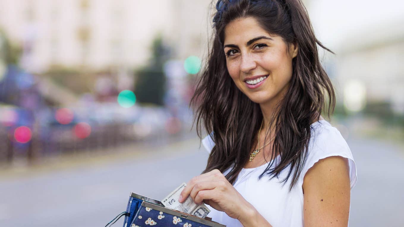 Frugal Habits Gen Z Is Borrowing From The Great Depression Era gen z woman saving money in her wallet