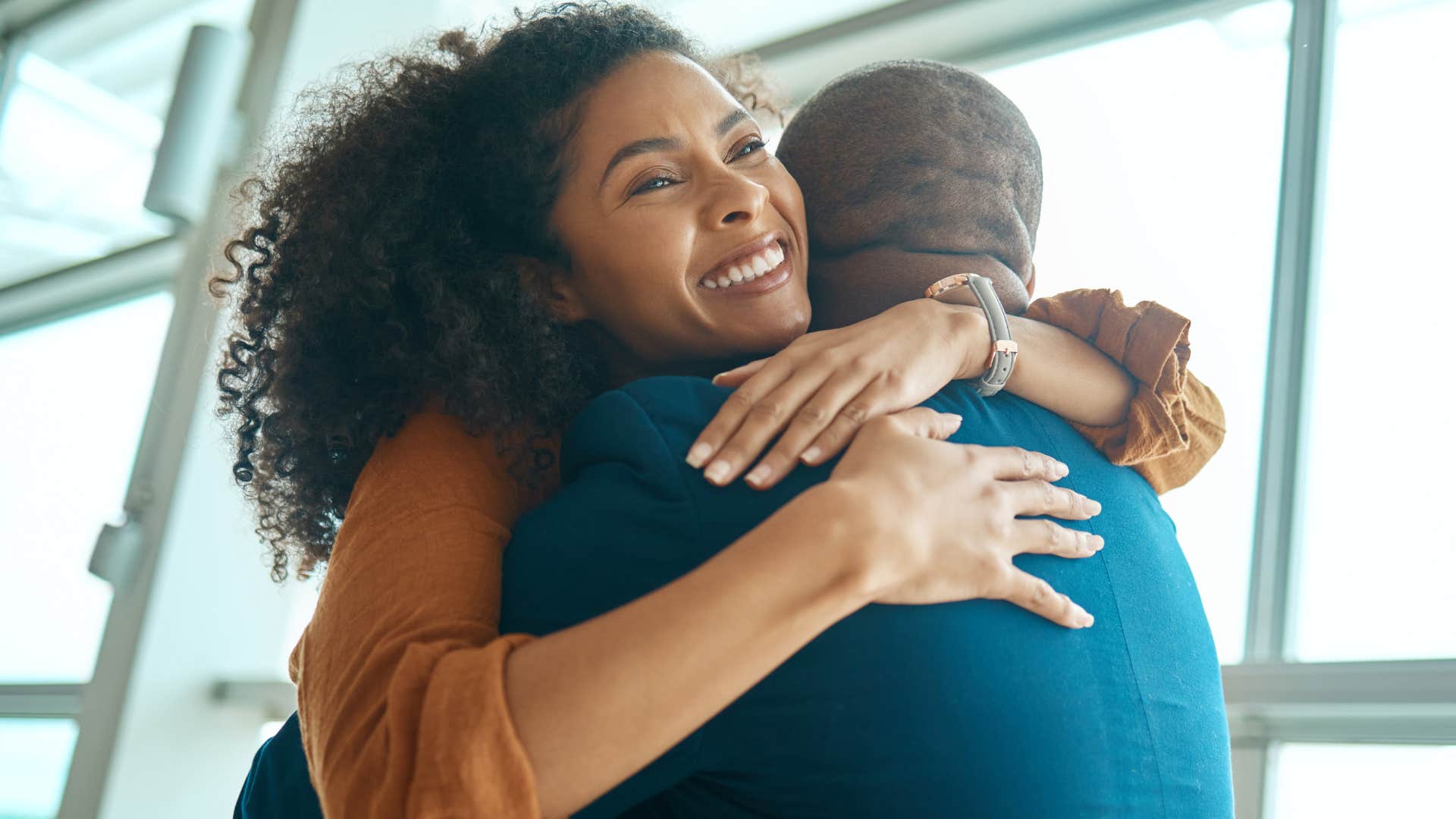 woman giving out small favor hugging her friend