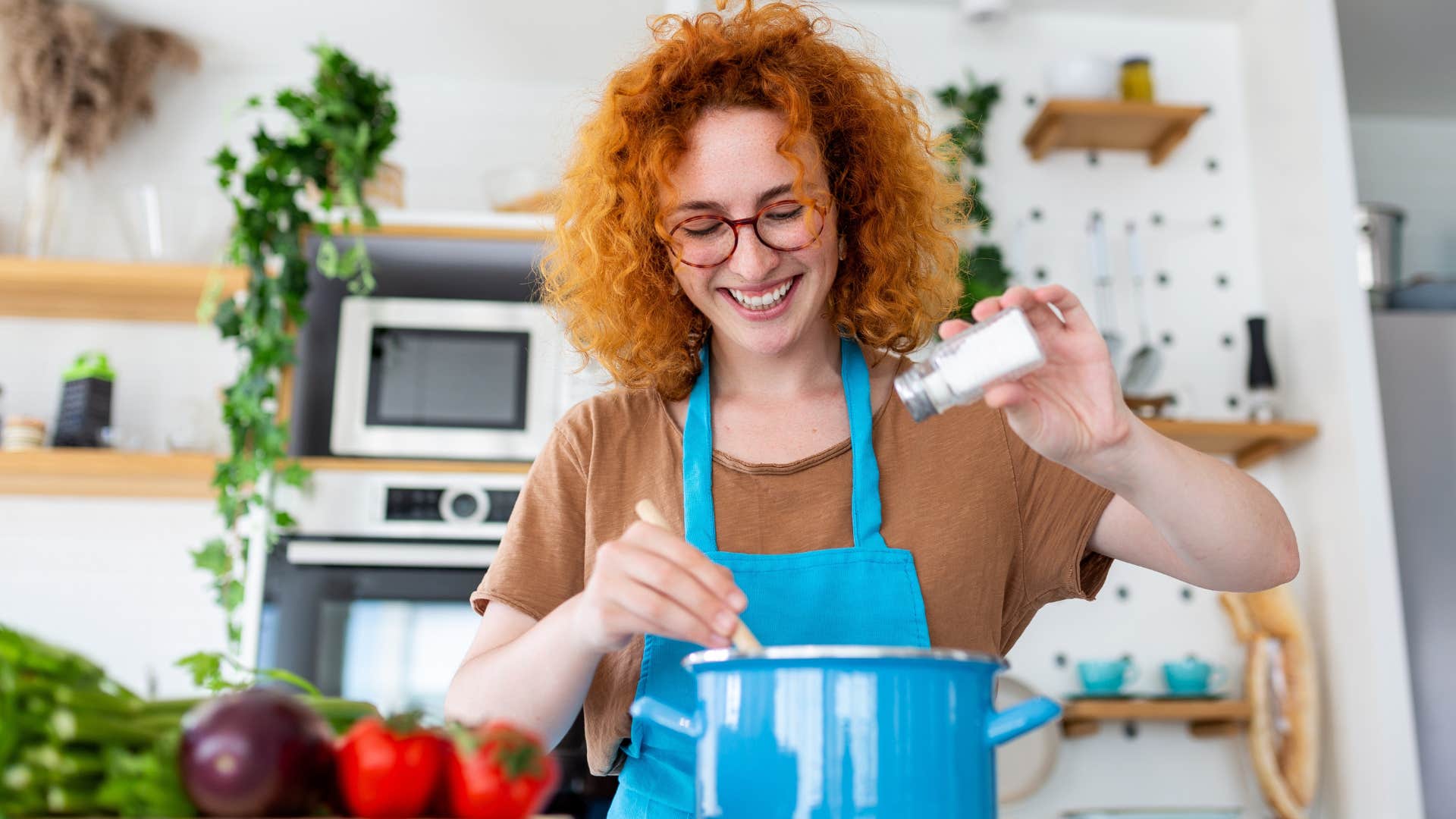 Gen Z woman stretching meals cooking in her kitchen