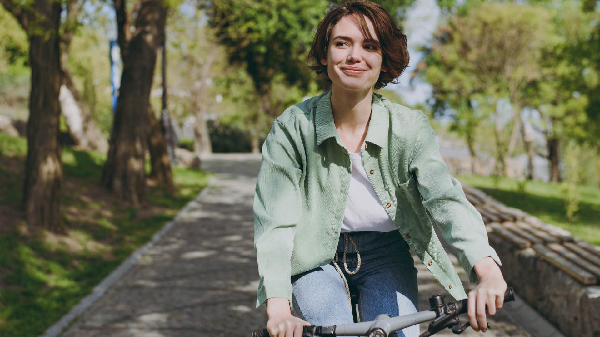 woman using her bike to get around the park