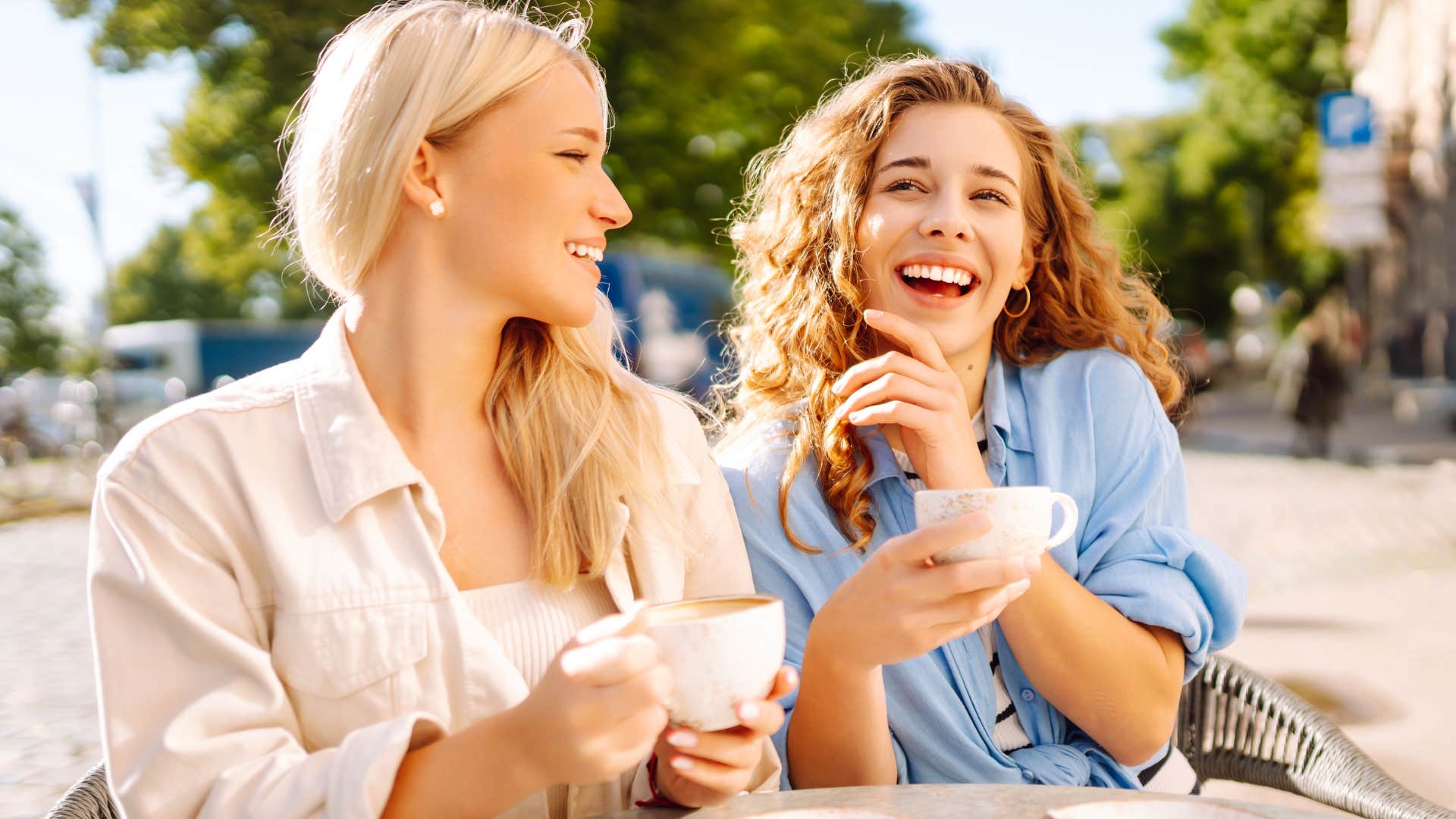 Two women smiling and being loud in public.