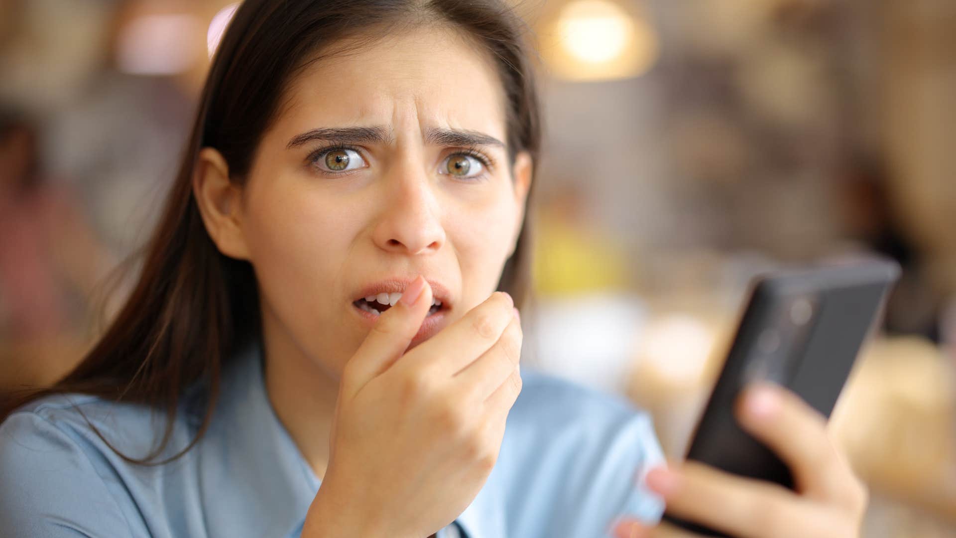 Woman checks phone as habit