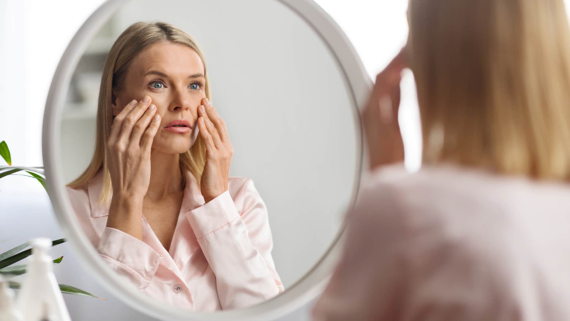 woman noticing dry skin as surprising change in appearance