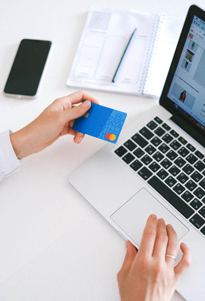 person holding credit card with their money on it