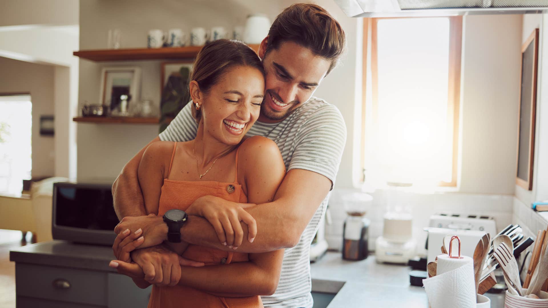 happy couple cooks for each other in the kitchen