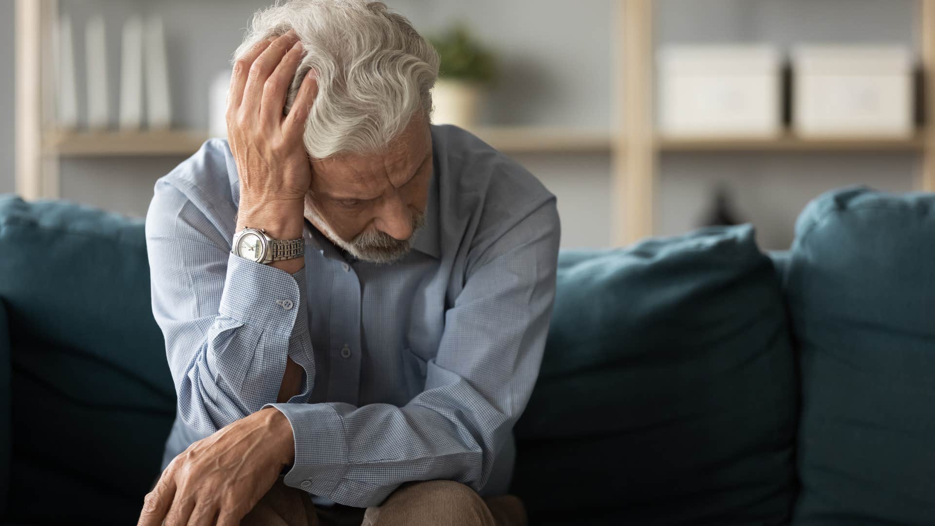 sad man who feels like hes failing holding his head