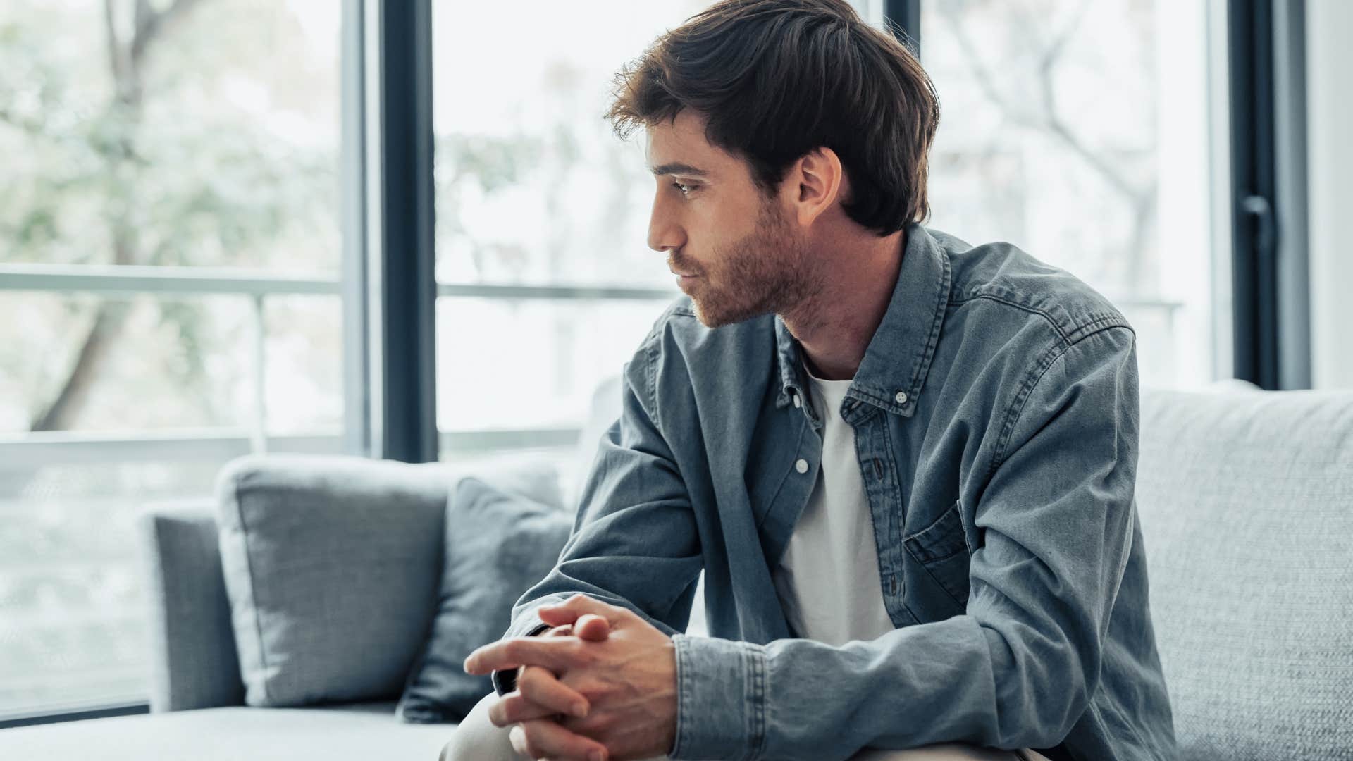sad man who fears abandonment sitting on a couch