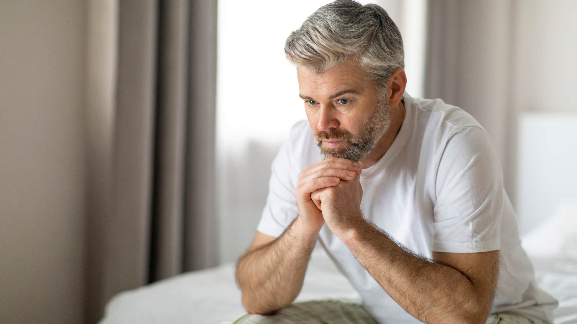upset man sitting alone afraid of confrontation