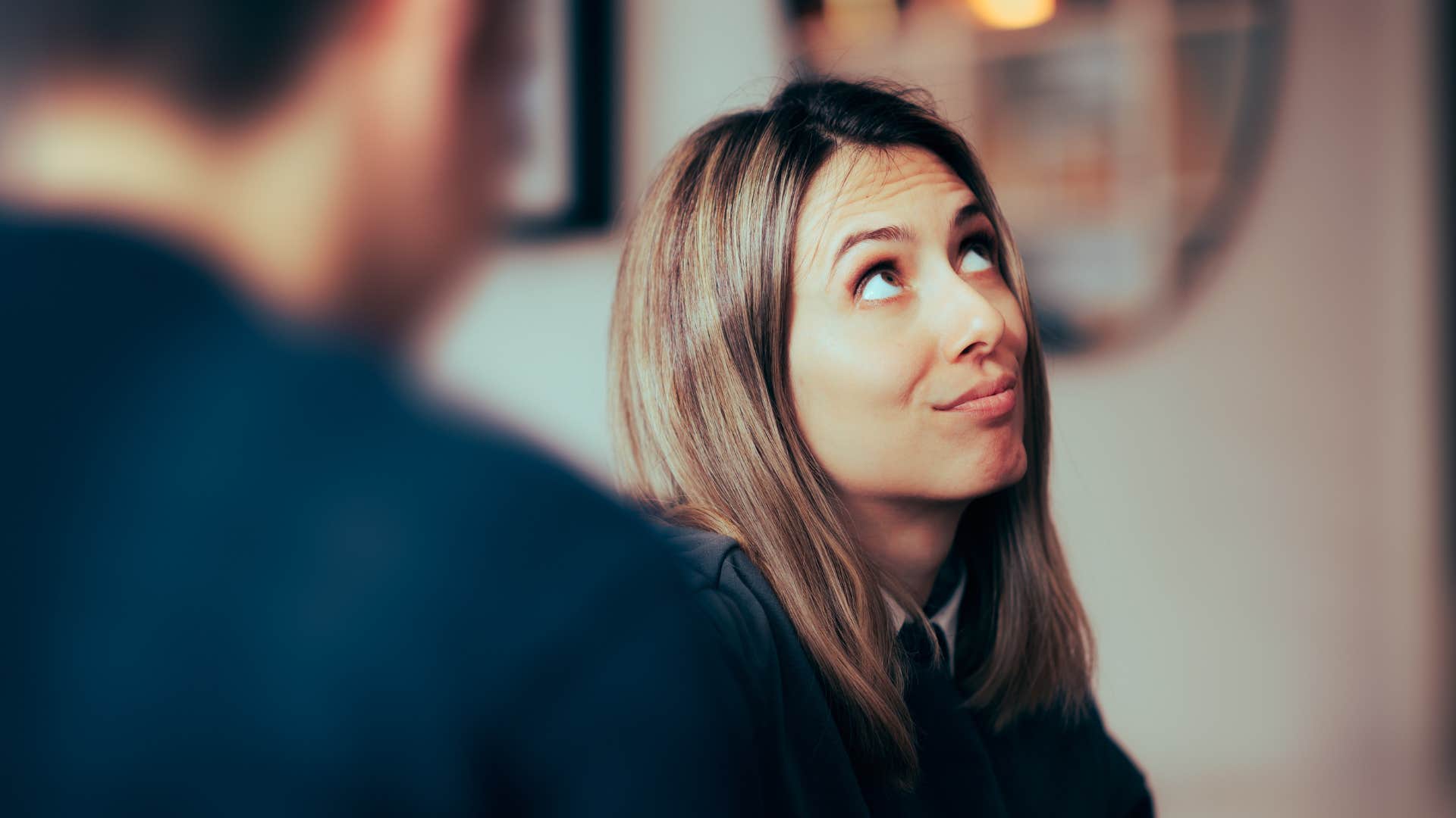 a woman rolls her eyes after her boyfriend brings up her past mistakes to win the argument
