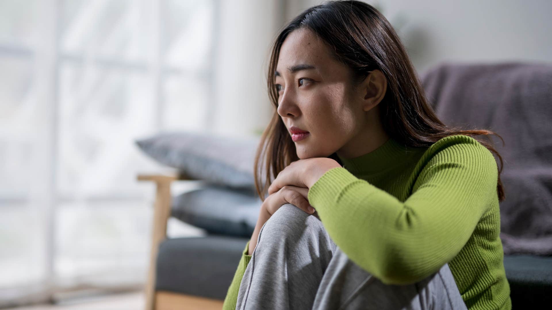 scared woman who struggles with vulnerability sitting alone