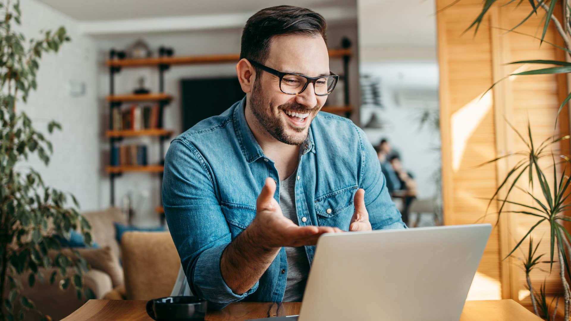 Man who's drawn to finding purpose smiling on his laptop.