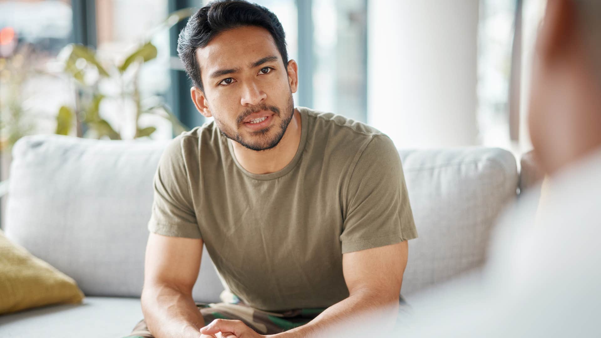 Annoyed man having a surface-level conversation with a friend.