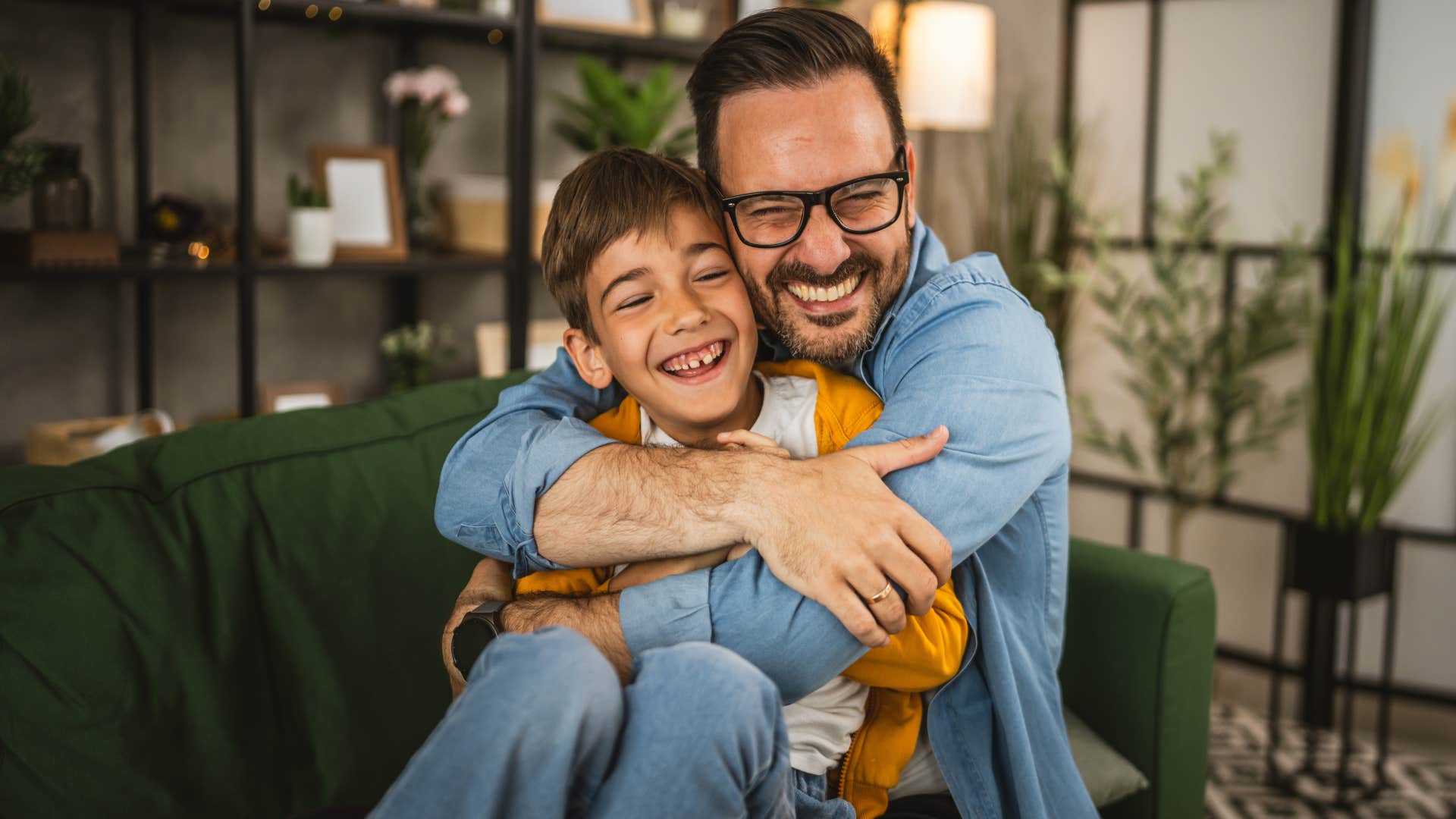 man smiling and hugging his son