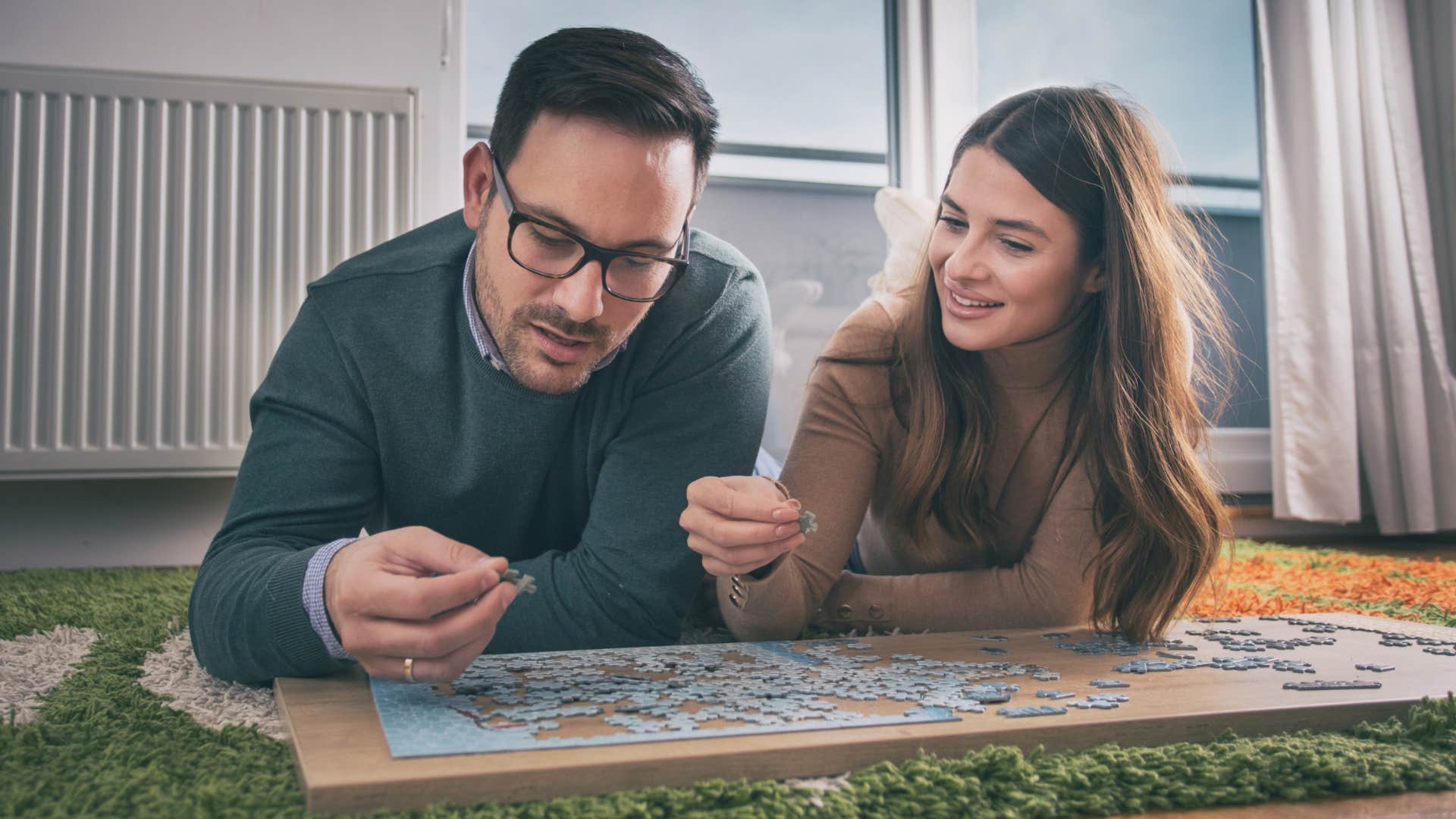 creative couple doing a jigsaw puzzle together