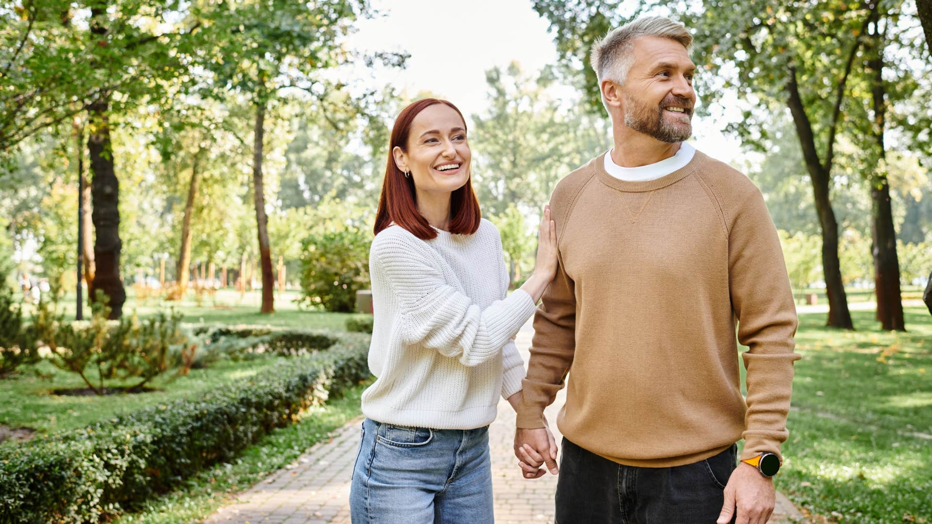happy couple taking a walk outside smiling