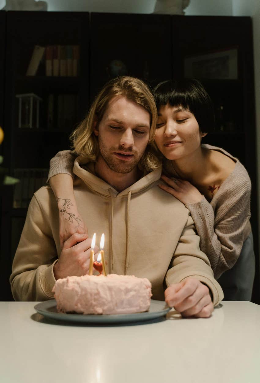 man looking at cake girlfriend made and disappointed it wasn't what he asked for