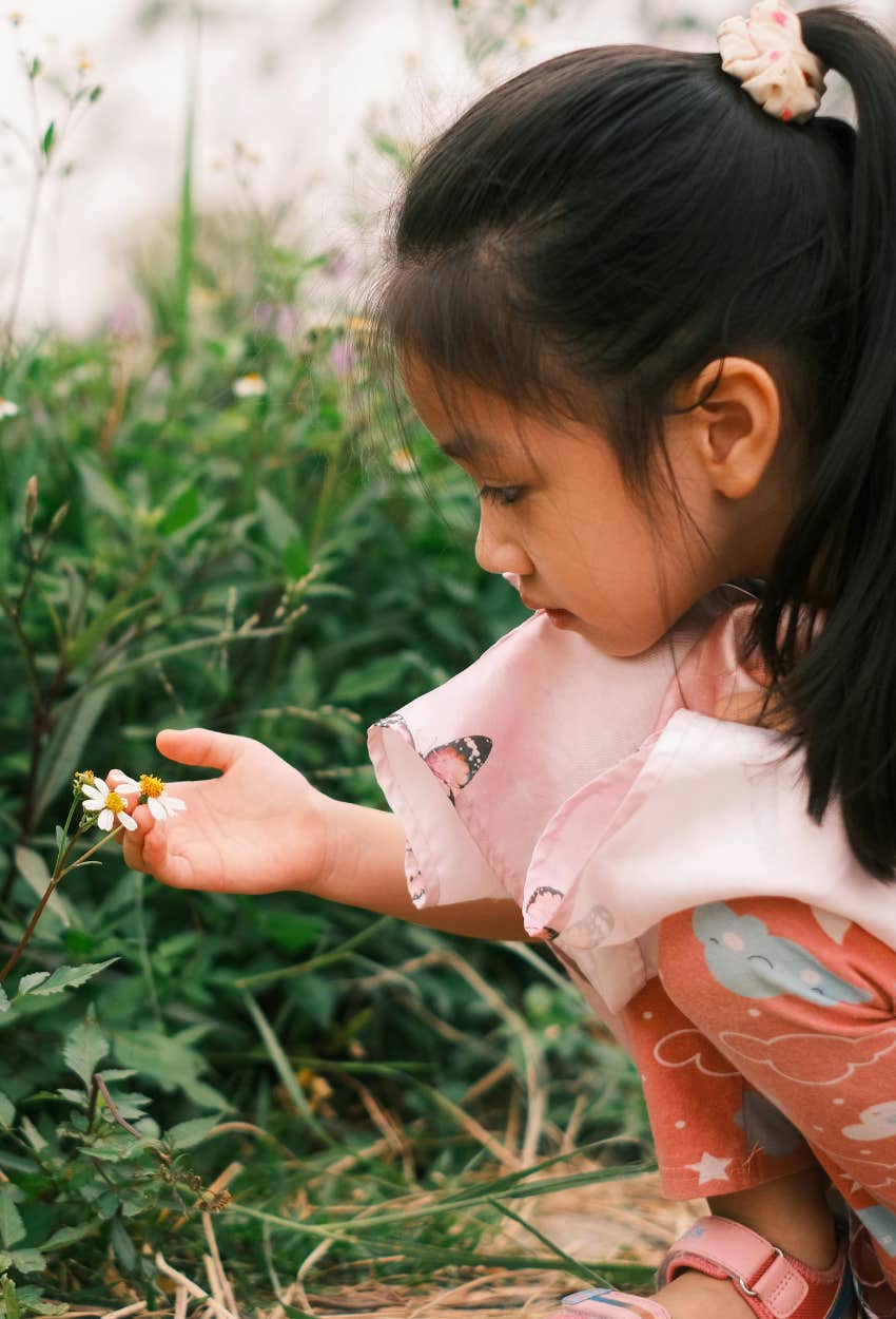 Little girl exploring her backyard