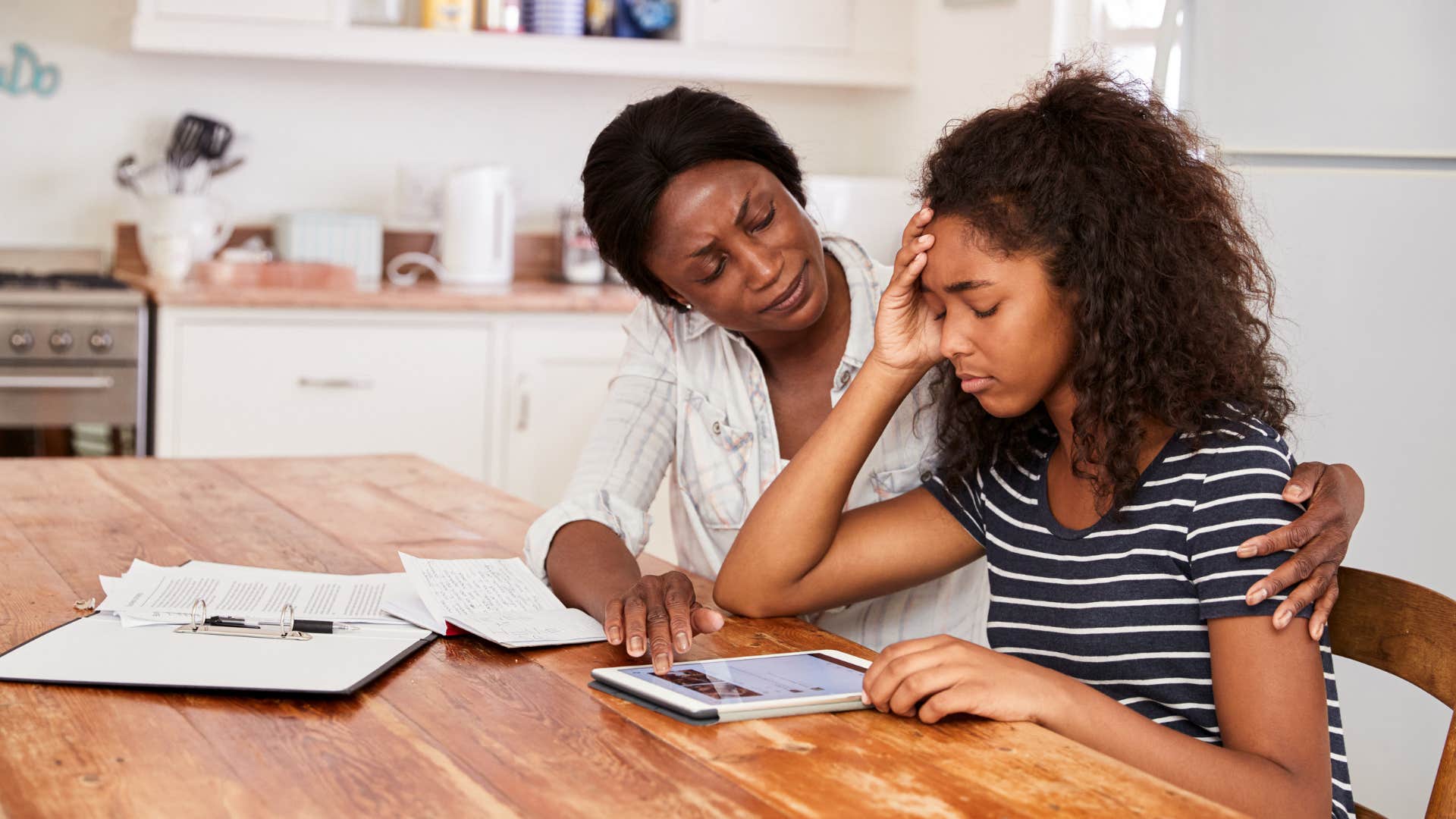 a mother listens to her teenage daughter