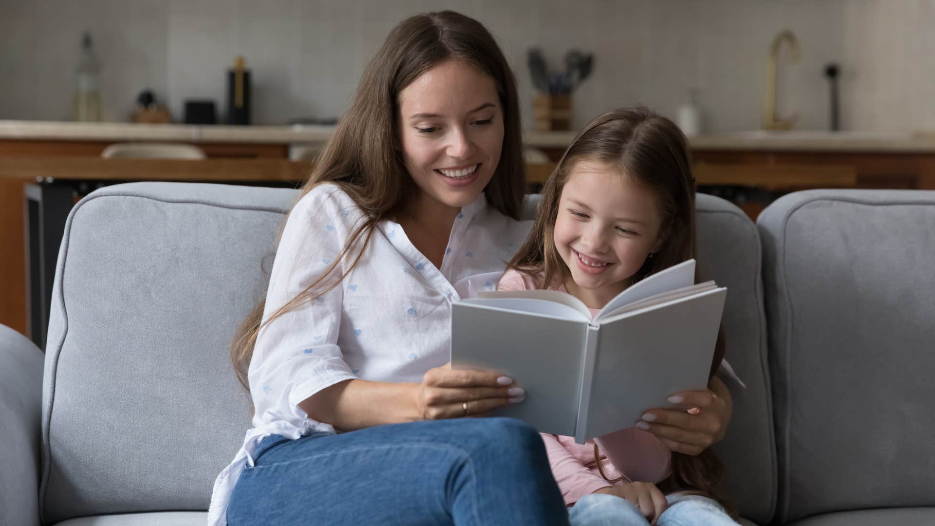 a mother reads to her daughter to instill a love of books