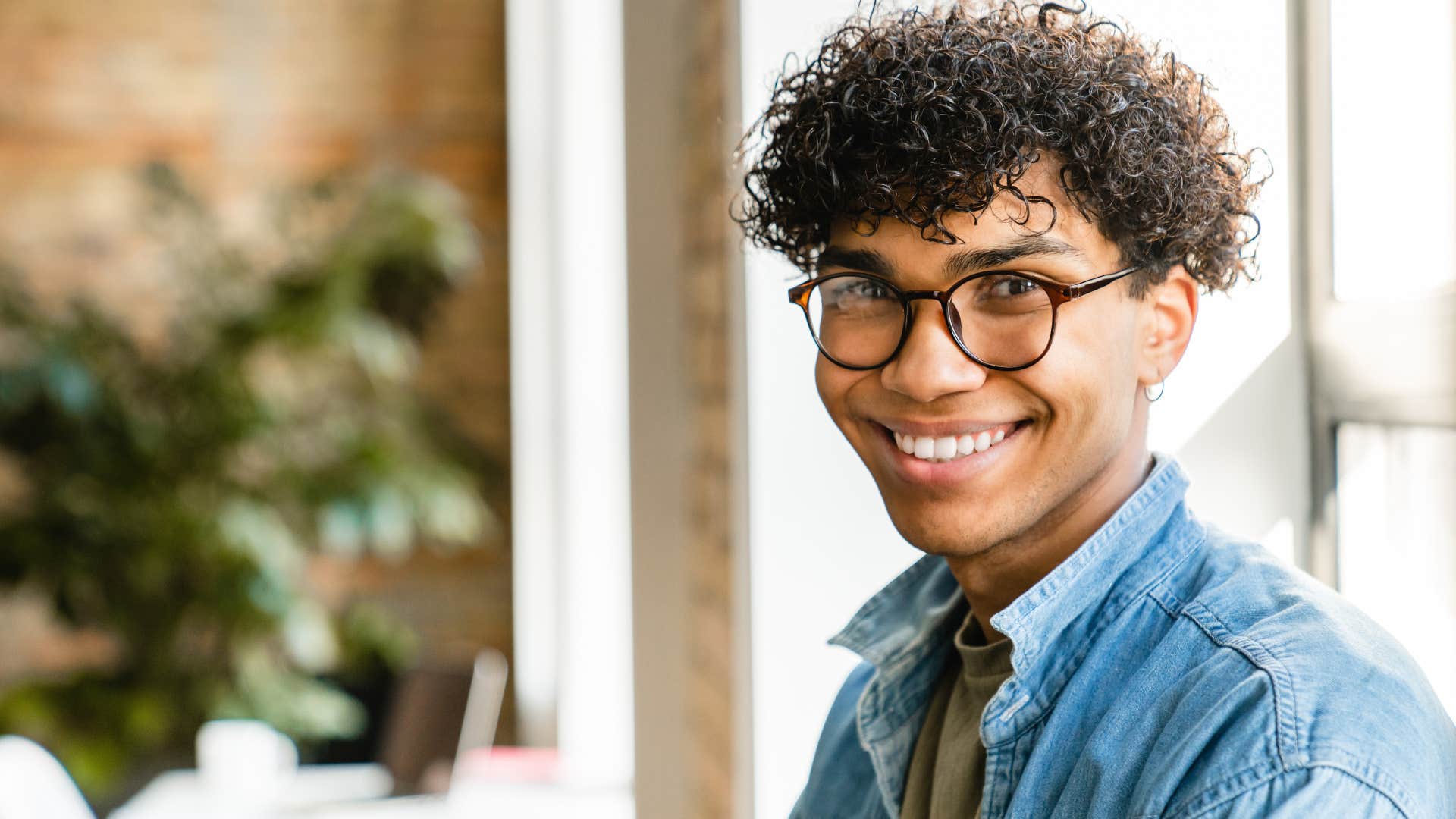Empathetic man smiling at the camera in a restaurant.