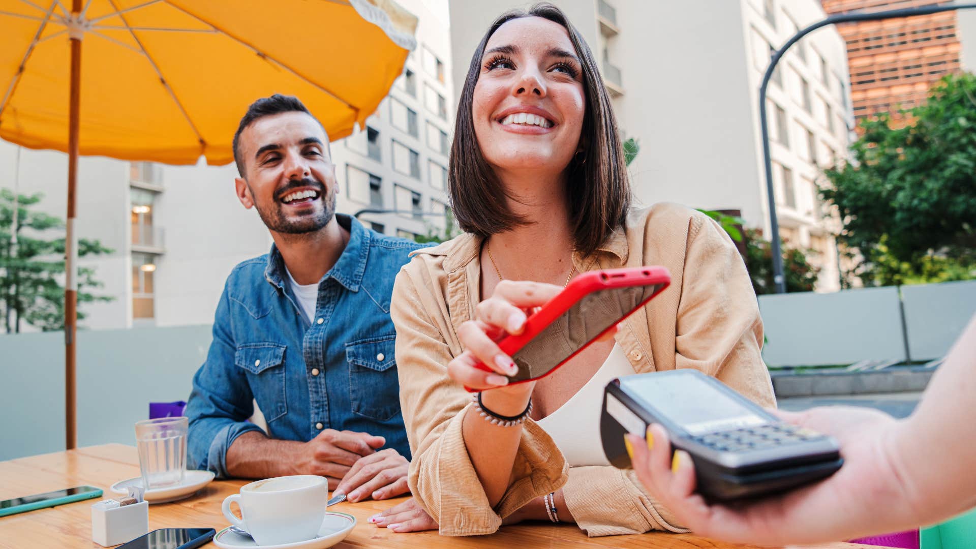 Woman who has integrity smiling and paying her bill at a restaurant.