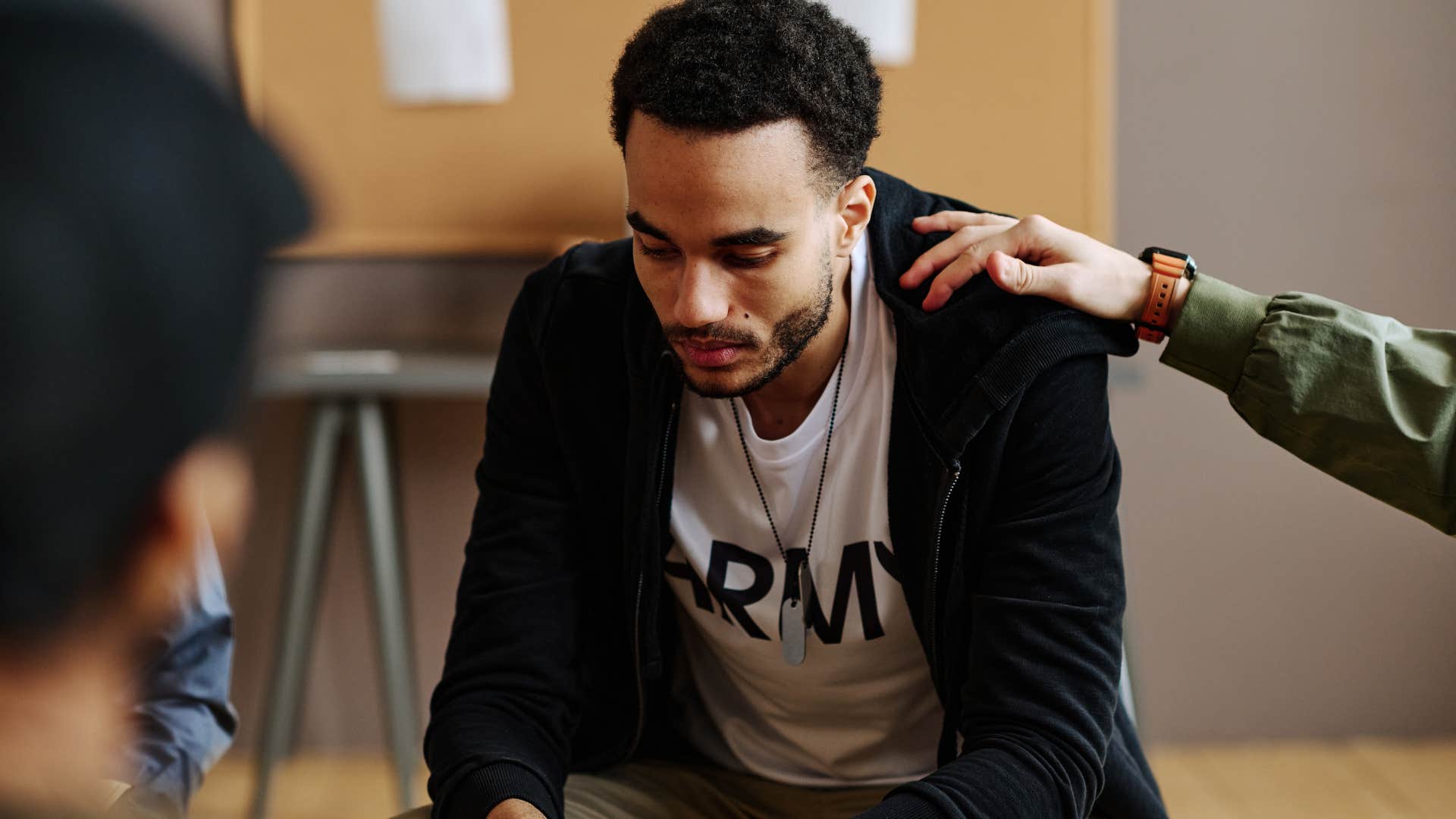 Grieving man looking sad in a support group