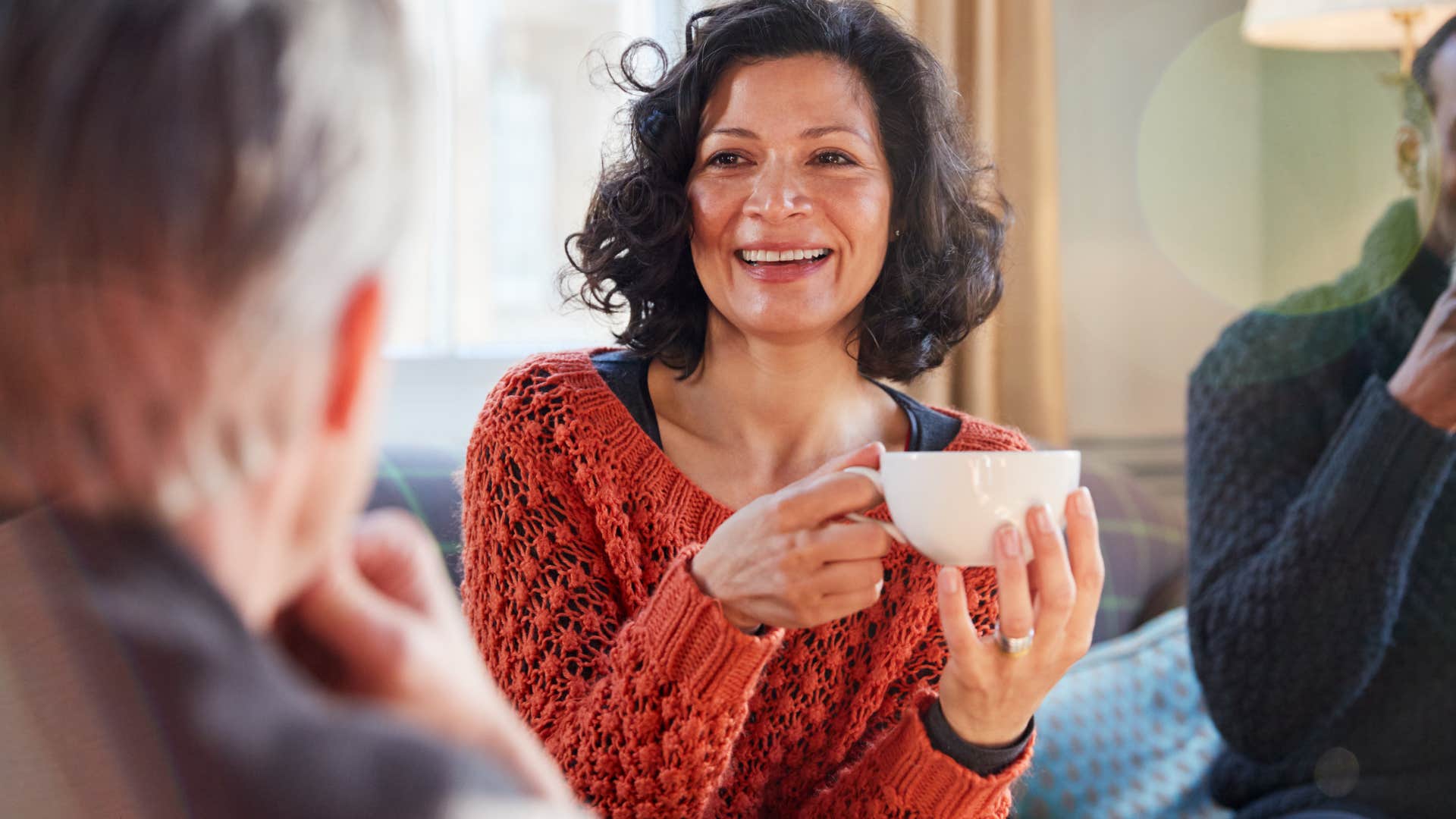 woman enjoying tea with friends smiling
