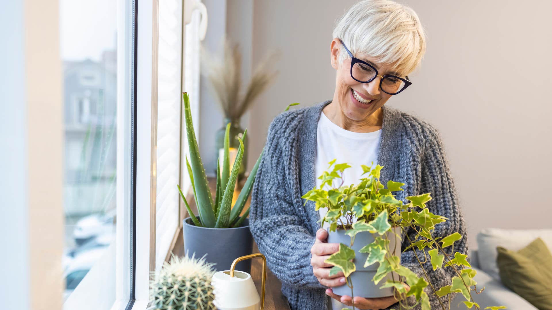 woman entertaining herself by taking care of indoor plants
