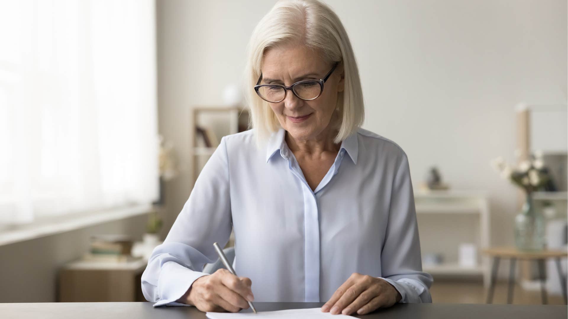 woman with great handwriting writing at her desk