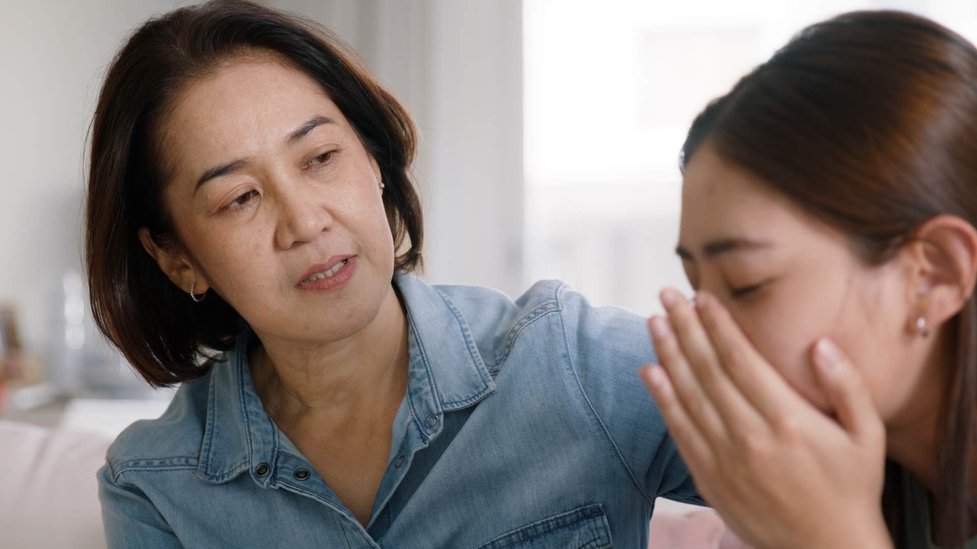 patient mother comforting upset adult daughter