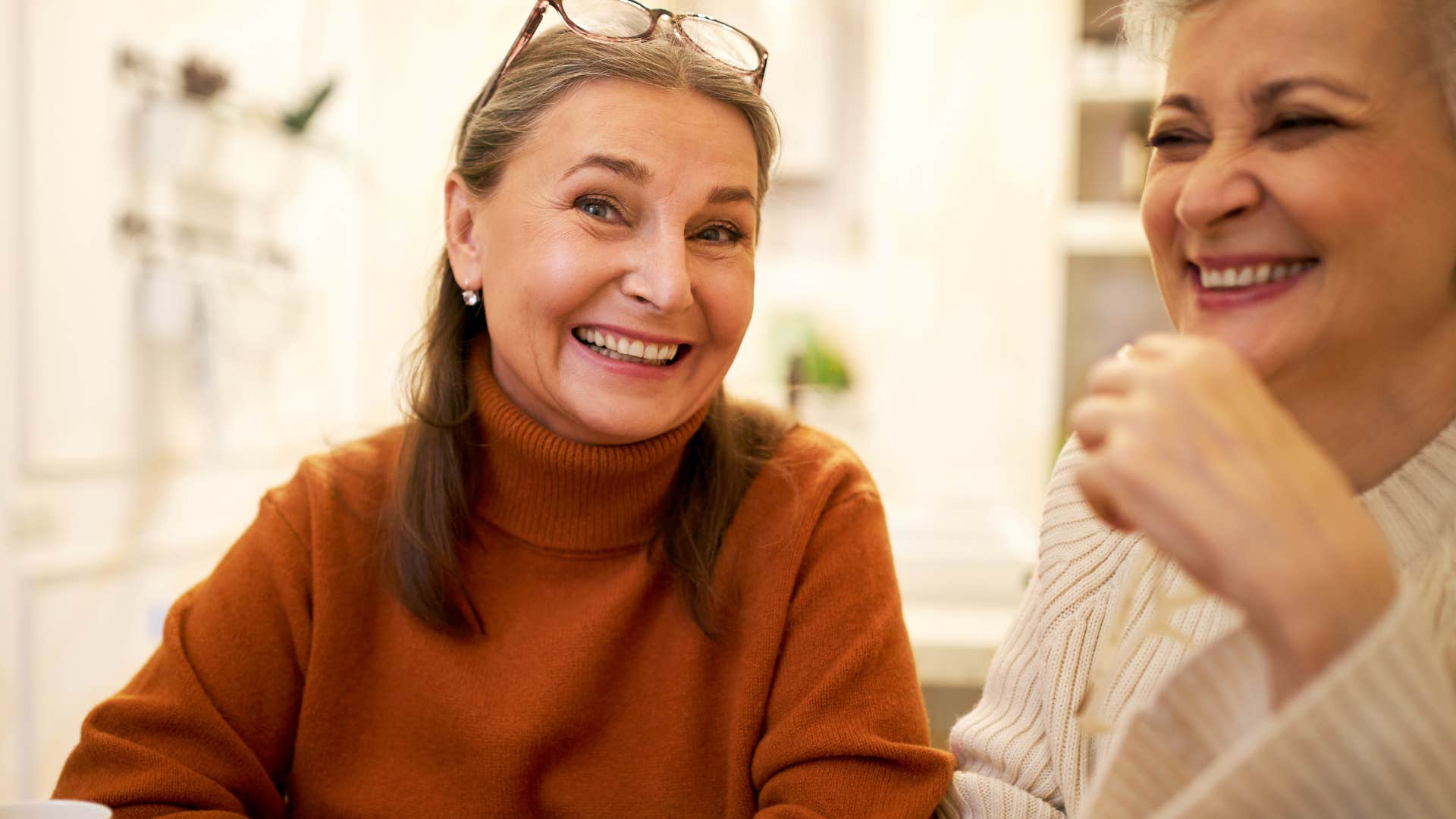 woman who's great at reading social cues smiling with friend