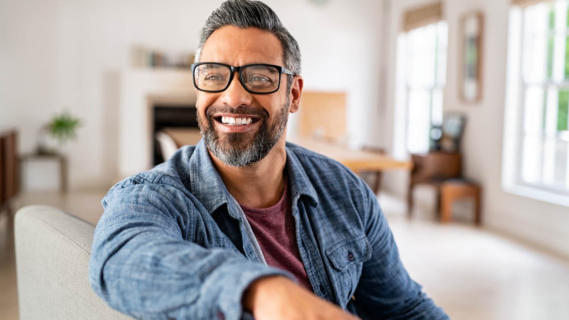 man smiling at home after setting a boundary