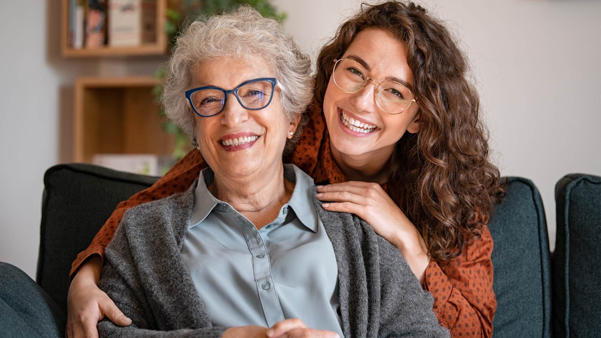 Woman hugging her adult daughter who doesn't have a lot of privacy.