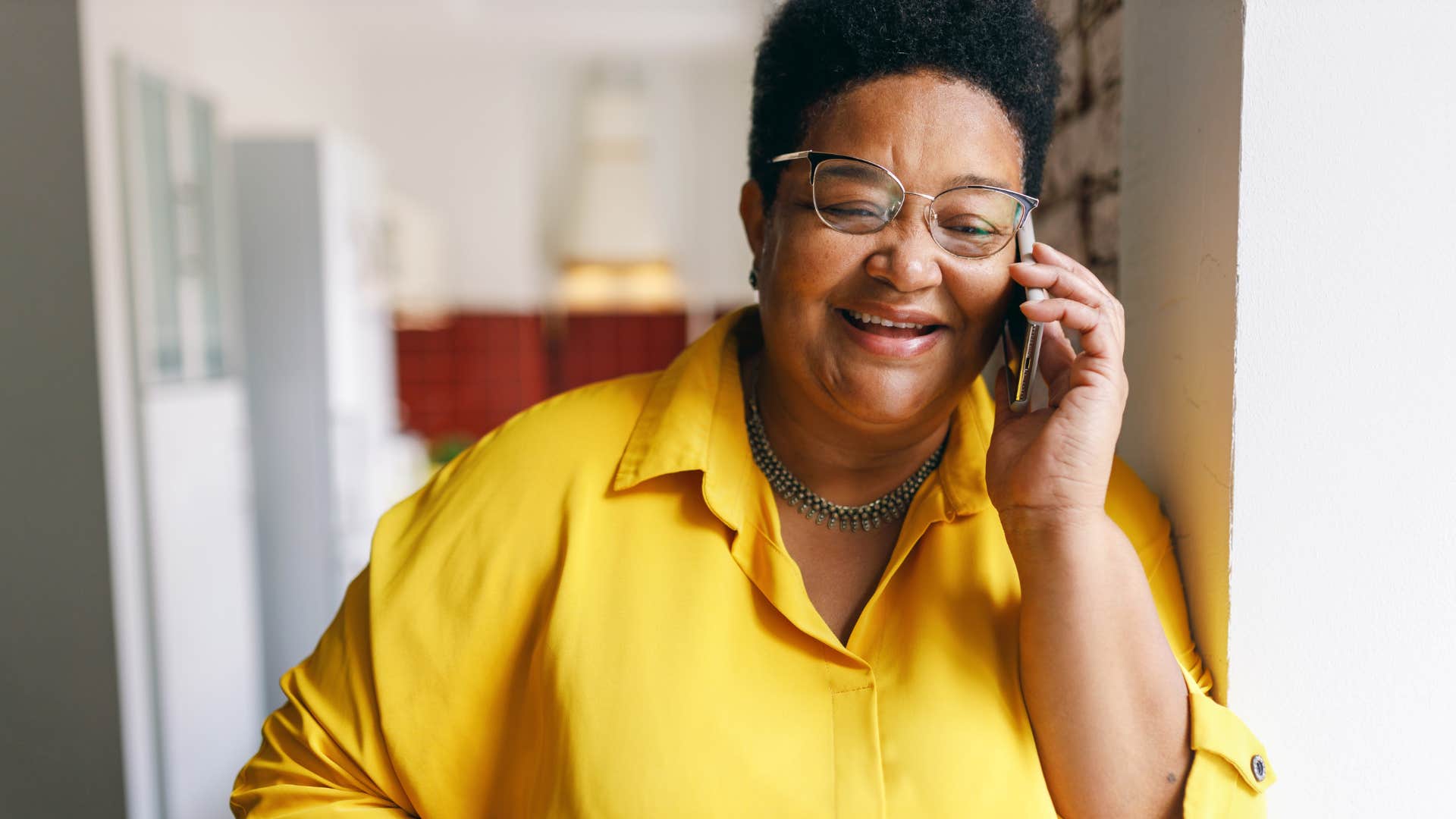 Woman with a small social circle smiling and talking on the phone.
