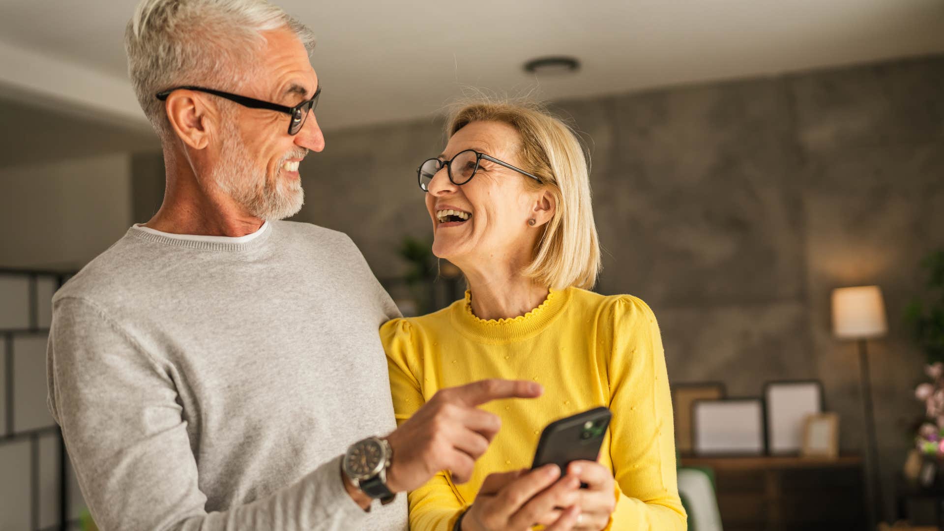 Woman who dislikes small talk looking at her phone with her husband.