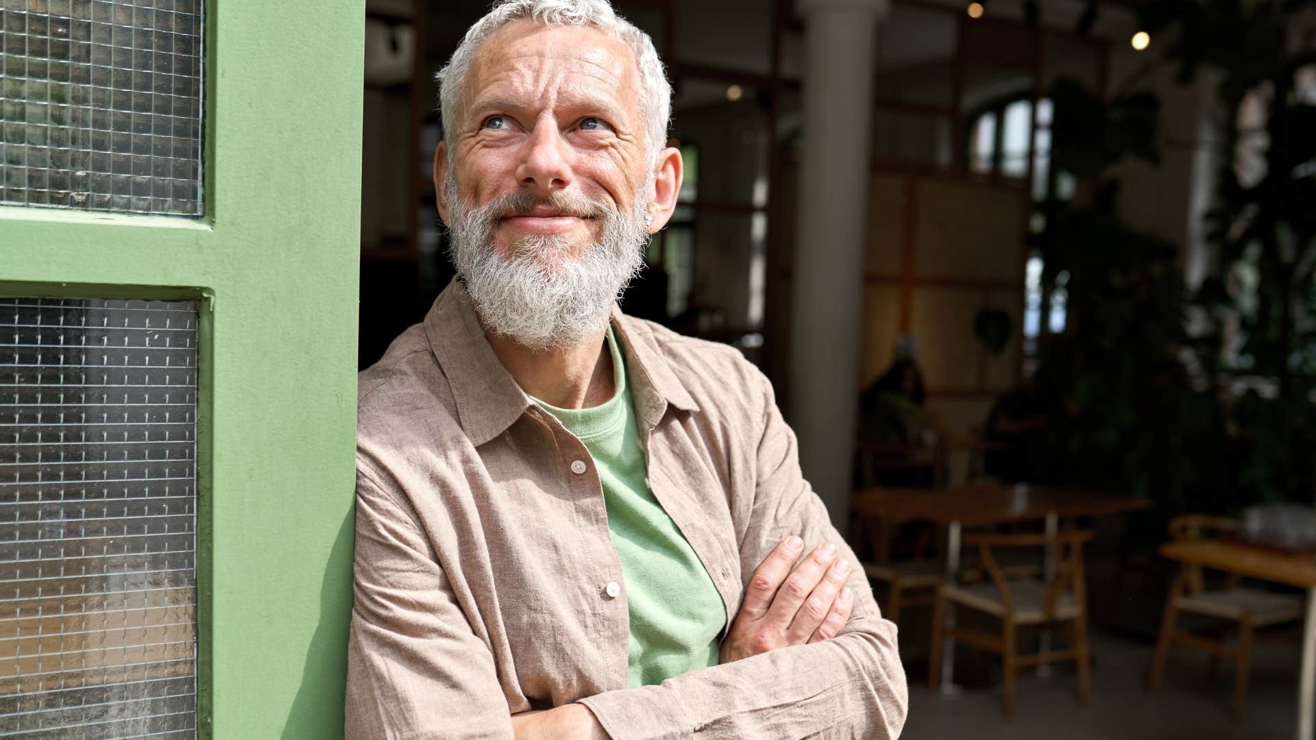 Man who doesn't compare themselves to others smiling outside.