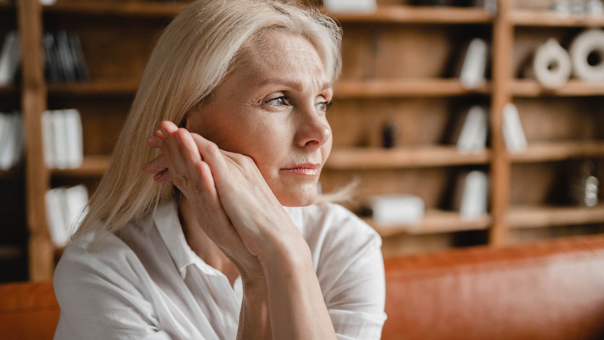 Woman who's focused on inner growth and peace looking out a window.