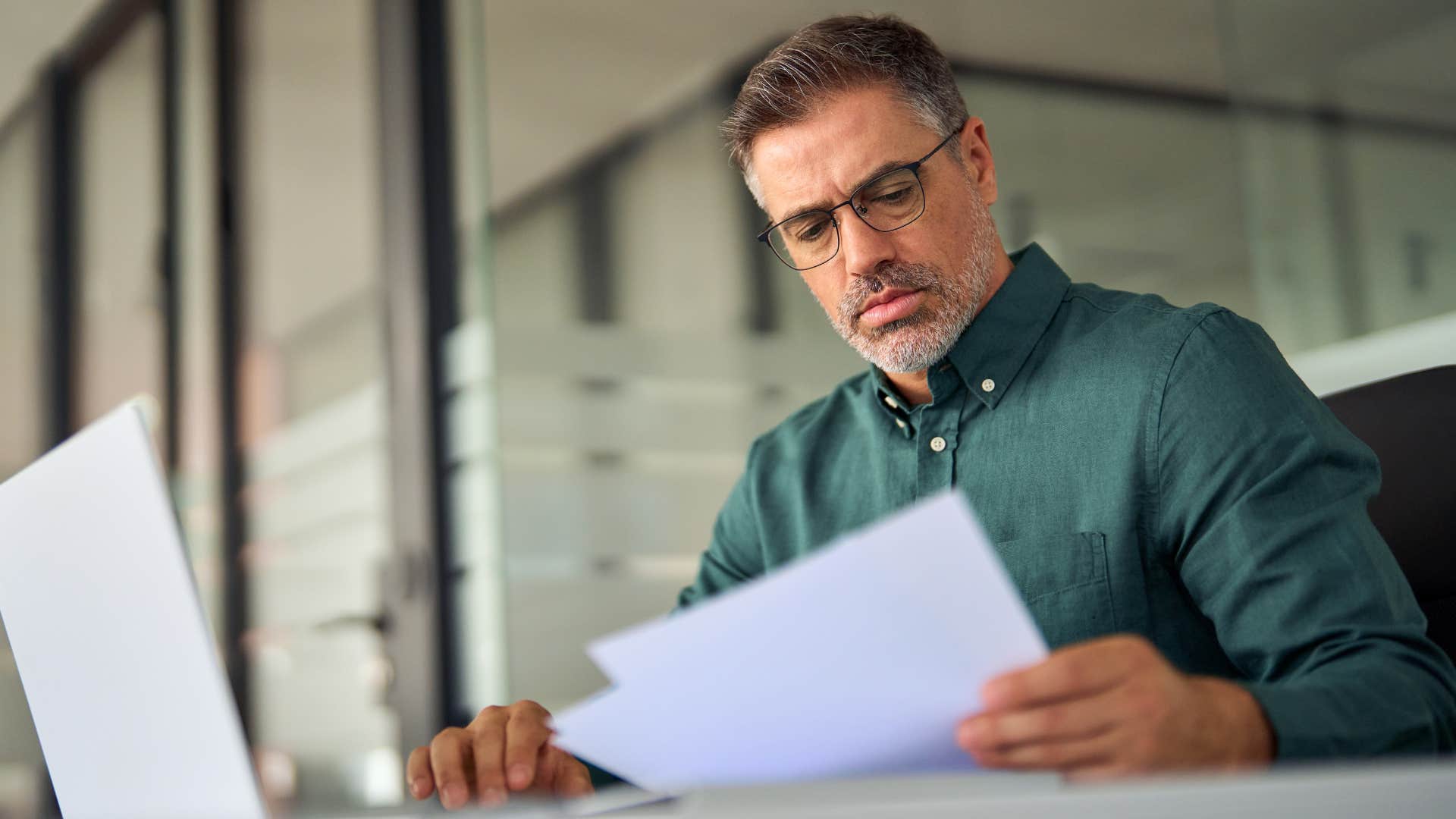 Man dealing with larger problems at his work desk.