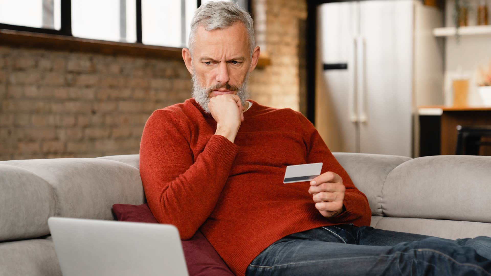 Man who doesn't have the money doing his bills at home.