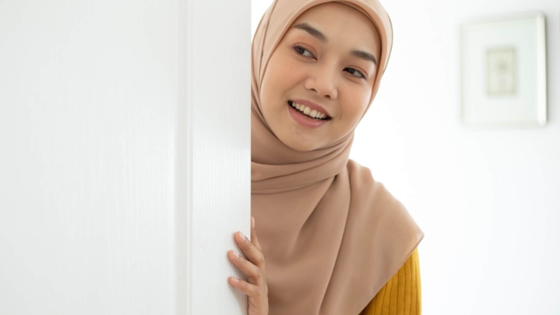 woman shutting her bedroom door in apartment 