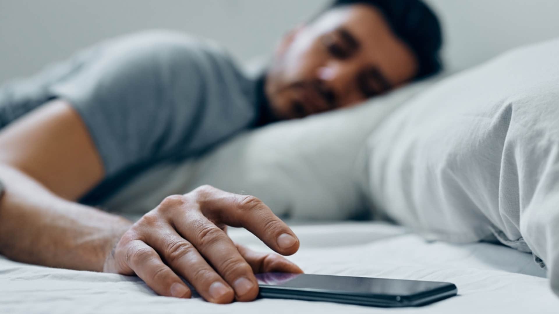 man muting his phone notifications 