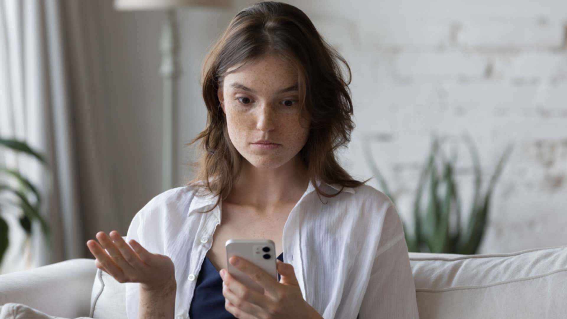woman refusing to answer phone looking confused