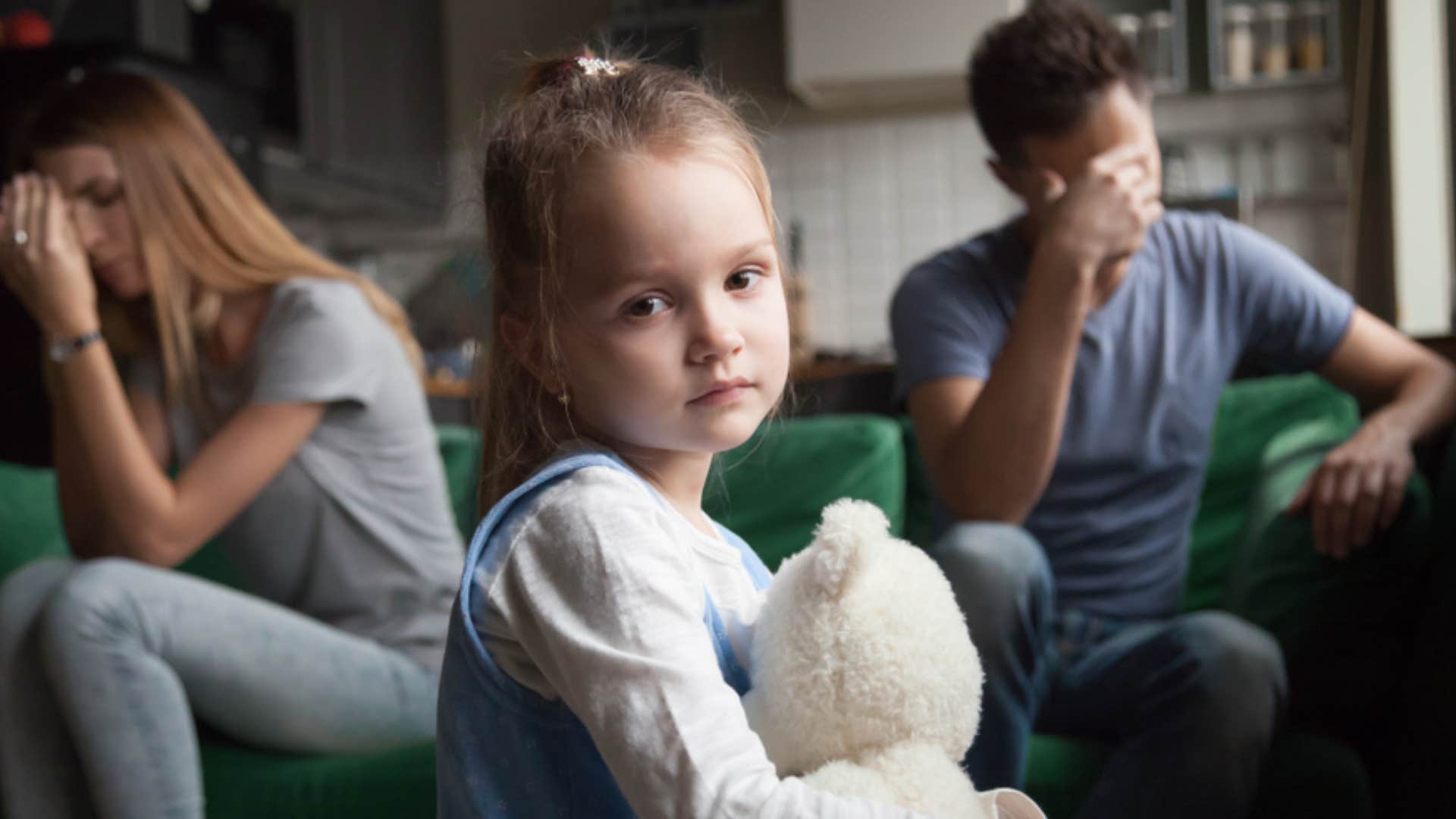 unhappy couple ignoring stressed out child 