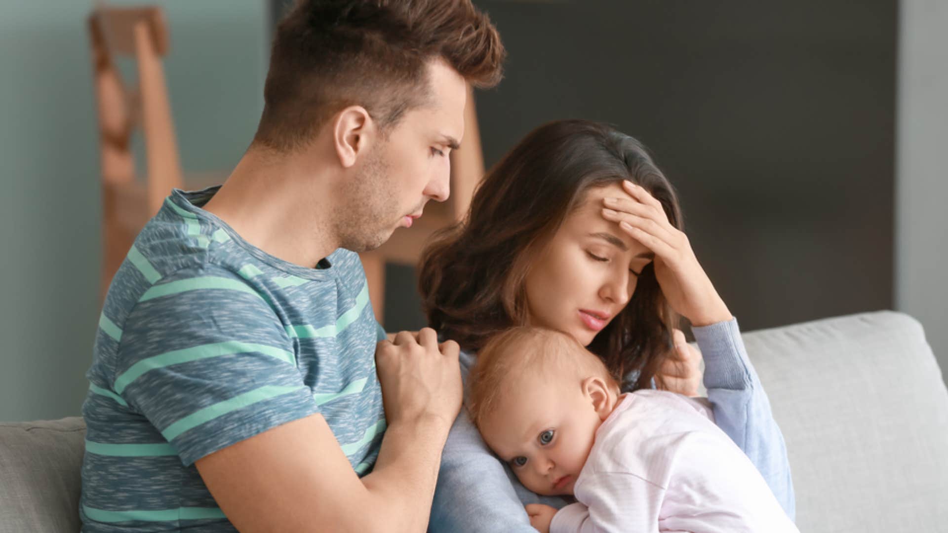 parents holding newborn convincing themselves marriage gets easier once kids grow up