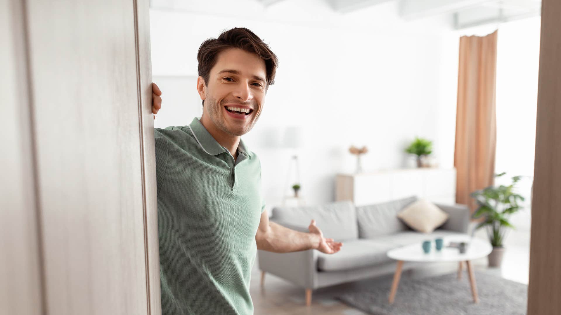 a man gives a warm greeting to his guests as he opens the door